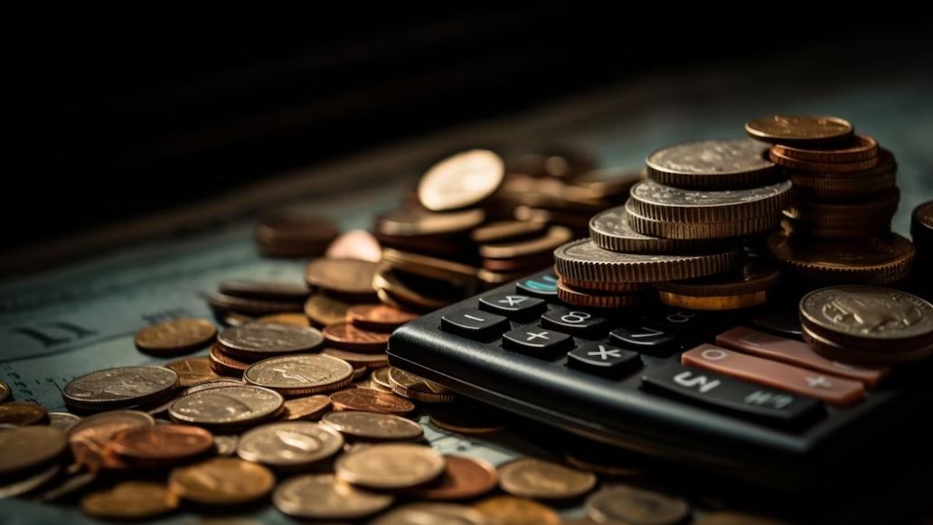 foto de calculadora com moedas em cima imagem da matéria dividendos da semana