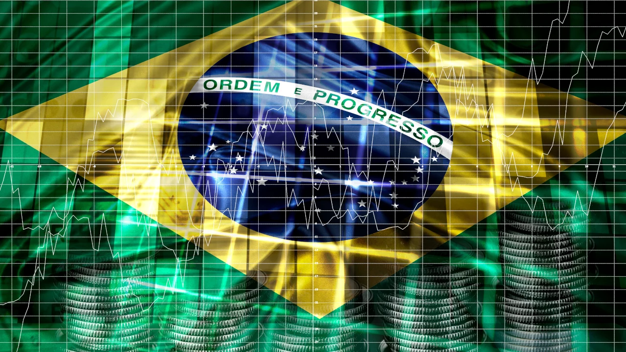 Foto para rating do Brasil, com bandeira nacional ao fundo de um gráfico financeiro