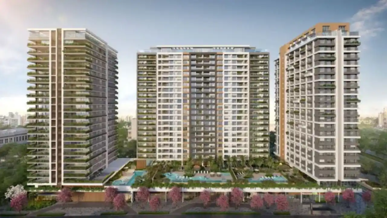 Perspectiva ilustrada de um condomínio residencial moderno da Trisul composto por três grandes torres com varandas arborizadas, áreas de lazer com piscinas no pavimento térreo e paisagismo florido ao redor.