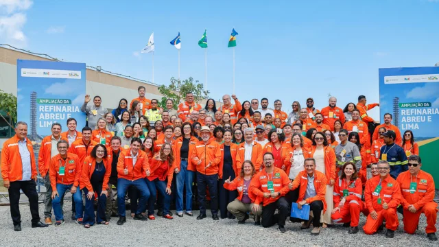 Grupo de petroleiros vestindo uniformes laranja em uma assembleia, simbolizando o início das discussões que podem levar a uma greve nacional na Petrobras.